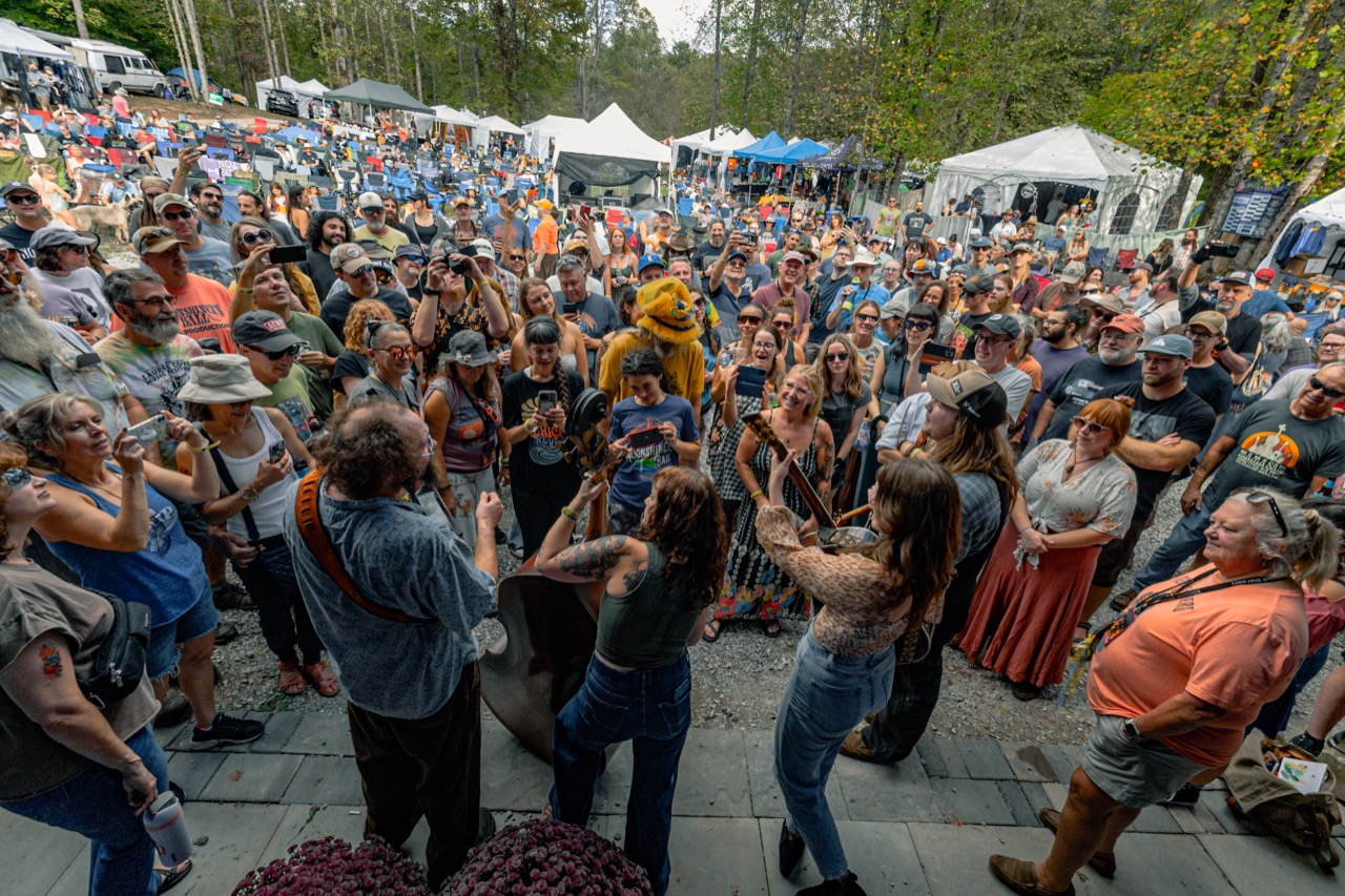Mama Said String Band performing for festival crowd at outdoor stage in daylight